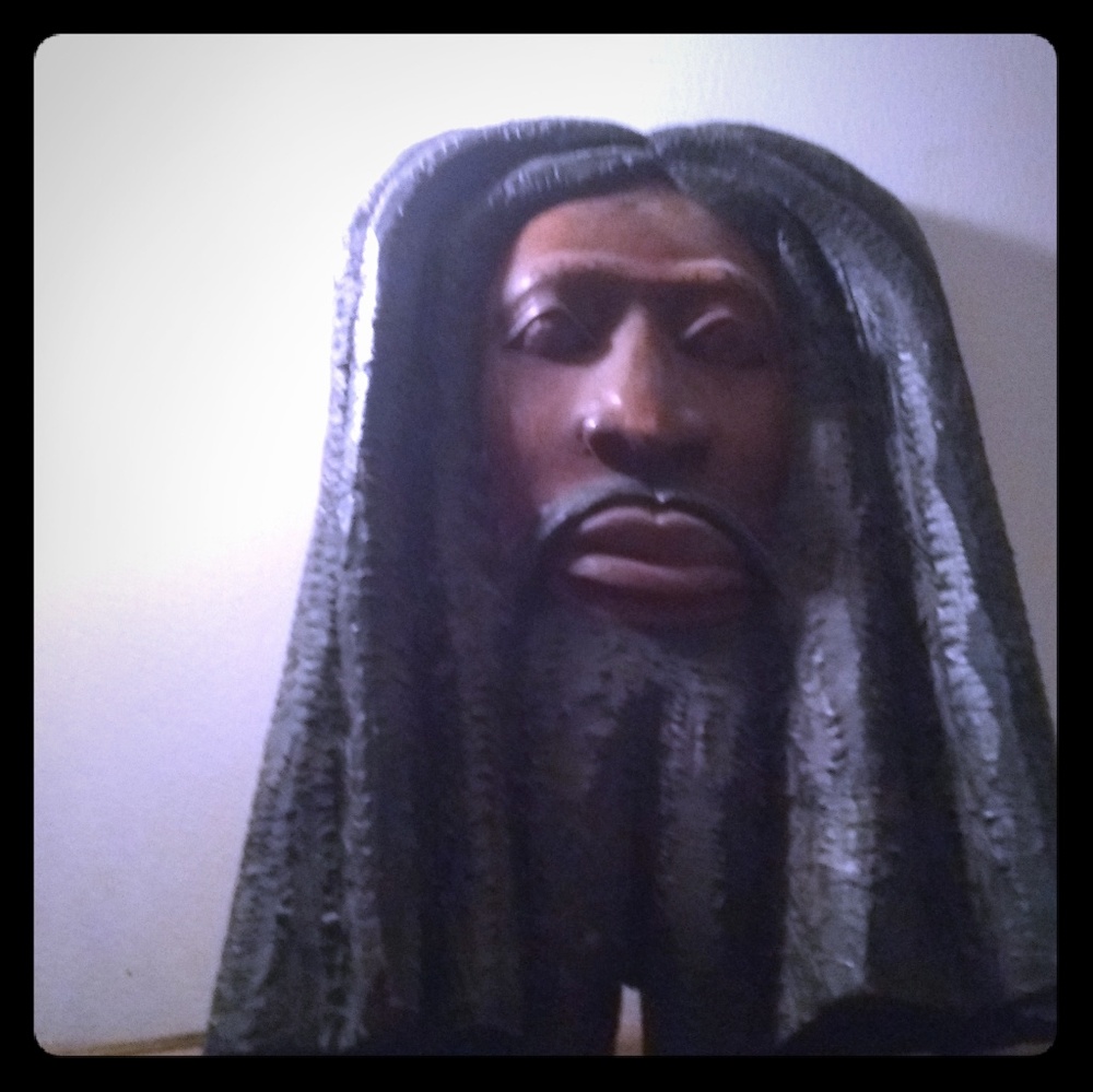 A wooden face wall plaque